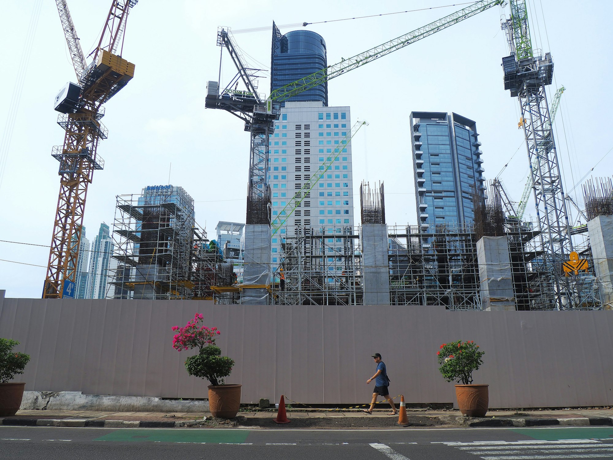 Tower cranes rising above the Jakarta skyline on a construction project